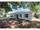 Charming single-story home with a carport, freshly painted white exterior, and well-maintained landscaping at 3813 Surrey Dr, Orlando, FL 32812