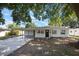 Charming single-story home boasting a carport, a dark front door and large windows at 3813 Surrey Dr, Orlando, FL 32812