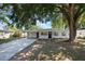 Inviting single-story home featuring a covered carport, fresh exterior paint, and a well-manicured front yard at 3813 Surrey Dr, Orlando, FL 32812