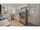 Bright kitchen featuring stainless steel appliances, light wood floors, white cabinets and modern countertops at 3813 Surrey Dr, Orlando, FL 32812