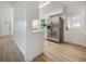 Bright kitchen featuring stainless steel appliances, light wood floors, white cabinets and modern countertops at 3813 Surrey Dr, Orlando, FL 32812