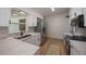 Bright kitchen with modern white cabinets, quartz counters, stainless steel appliances, and wood floors at 3813 Surrey Dr, Orlando, FL 32812
