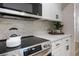 Close up of kitchen with white countertops, modern appliances, and stylish backsplash at 3813 Surrey Dr, Orlando, FL 32812