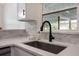 Kitchen sink with black faucet and white quartz countertops at 3813 Surrey Dr, Orlando, FL 32812