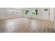 Spacious living room featuring modern light wood flooring, large windows, and a front door at 3813 Surrey Dr, Orlando, FL 32812