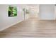Large living room featuring modern light wood flooring, lots of windows, and ample natural light at 3813 Surrey Dr, Orlando, FL 32812