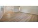 Large living room featuring modern light wood flooring and access to the kitchen at 3813 Surrey Dr, Orlando, FL 32812