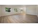 Large living room featuring modern light wood flooring, lots of windows, and ample natural light at 3813 Surrey Dr, Orlando, FL 32812