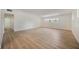Spacious living room featuring modern light wood flooring, large windows, and ample natural light at 3813 Surrey Dr, Orlando, FL 32812