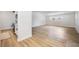 Bright living room leading to the kitchen, featuring modern light wood flooring and ample natural light at 3813 Surrey Dr, Orlando, FL 32812