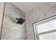 Contemporary shower with marble-style tiling, a rainfall showerhead, and a window at 3813 Surrey Dr, Orlando, FL 32812
