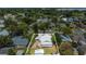 Aerial view showcases property, bordered by a white outline, set within a neighborhood with mature trees at 1013 Pennsylvania Ave, Lakeland, FL 33803