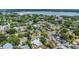 Picturesque aerial view of a neighborhood with tree-lined streets, houses, and a serene lake in the background at 1013 Pennsylvania Ave, Lakeland, FL 33803