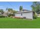 Side view of home showing landscaped yard, well-manicured lawn, and AC unit at 1013 Pennsylvania Ave, Lakeland, FL 33803