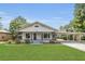 Charming single-story home with a covered porch and carport in a mature setting at 1013 Pennsylvania Ave, Lakeland, FL 33803