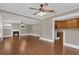 Open-concept living room with hardwood floors, fireplace, and adjoining kitchen at 1013 Pennsylvania Ave, Lakeland, FL 33803