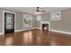 Bright living room features hardwood floors, fireplace, ceiling fan, and natural light at 1013 Pennsylvania Ave, Lakeland, FL 33803