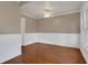 A spacious living room with hardwood floors, white trim, and ceiling fan at 1013 Pennsylvania Ave, Lakeland, FL 33803