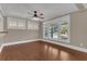 Living room featuring hardwood floors, white trim, and three large windows at 1013 Pennsylvania Ave, Lakeland, FL 33803