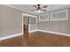 View of living room with hardwood floors, bar top seating, and white trim at 1013 Pennsylvania Ave, Lakeland, FL 33803