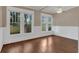 Bright living room with hardwood floors, white trim, and large windows providing natural light at 1013 Pennsylvania Ave, Lakeland, FL 33803