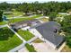 Aerial view of a home featuring a screened pool, fenced yard, and well-manicured landscaping at 1130 Ewell Rd, Lakeland, FL 33811