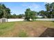 The backyard features an enclosed fence with a shed and mature trees at 1130 Ewell Rd, Lakeland, FL 33811