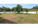 Large backyard with mature trees and a white fence surrounding the perimeter at 1130 Ewell Rd, Lakeland, FL 33811
