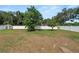 Large backyard with mature trees and a white fence surrounding the perimeter at 1130 Ewell Rd, Lakeland, FL 33811