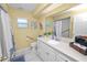 Well-lit bathroom with a spacious vanity, a large mirror, and accessibility features at 1130 Ewell Rd, Lakeland, FL 33811