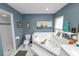 Cozy bathroom features jacuzzi tub, walk in shower, toilet, blue walls, and decor at 1130 Ewell Rd, Lakeland, FL 33811