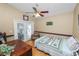 Cozy bedroom boasts a ceiling fan, access to the outdoors, and wood-look flooring at 1130 Ewell Rd, Lakeland, FL 33811