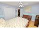Light-filled bedroom featuring a wooden bench, ceiling fan, and spacious closet at 1130 Ewell Rd, Lakeland, FL 33811