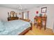 Bedroom with a ceiling fan, hardwood floors and a door leading to the backyard pool at 1130 Ewell Rd, Lakeland, FL 33811