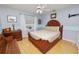 This bedroom has blue walls, a ceiling fan, hardwood floors and a wooden bench at 1130 Ewell Rd, Lakeland, FL 33811