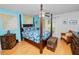 This spacious bedroom features hardwood floors, a ceiling fan, and tropical style furniture at 1130 Ewell Rd, Lakeland, FL 33811
