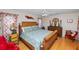 Comfortable bedroom featuring hardwood floors, ceiling fan, unique furnishings and a decorative headboard at 1130 Ewell Rd, Lakeland, FL 33811