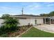 Charming home featuring a front entrance with a well-maintained lawn and beautiful landscaping at 1130 Ewell Rd, Lakeland, FL 33811