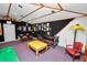 Spacious game room features vintage decor, comfortable seating, and unique lighting at 1130 Ewell Rd, Lakeland, FL 33811