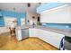 Open kitchen featuring stainless steel dishwasher, granite countertops, and breakfast bar at 1130 Ewell Rd, Lakeland, FL 33811
