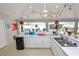 Outdoor kitchen features a mini fridge, a microwave, and a sink with views of the pool at 1130 Ewell Rd, Lakeland, FL 33811