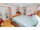 Spacious main bedroom with hard wood floors and a large decorative bed at 1130 Ewell Rd, Lakeland, FL 33811