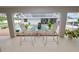 Relaxing patio area with a table and chairs overlooking the pool, perfect for outdoor dining at 1130 Ewell Rd, Lakeland, FL 33811