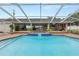 Lovely pool area with a spa and covered bar, ideal for outdoor entertaining and relaxation at 1130 Ewell Rd, Lakeland, FL 33811