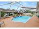 Great shot of the pool in the backyard with great patio space and a screened-in porch at 1130 Ewell Rd, Lakeland, FL 33811