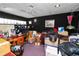 Cluttered room with personal belongings, a wooden desk, and dark walls at 1130 Ewell Rd, Lakeland, FL 33811