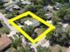 An aerial view of a home surrounded by trees, with a bright yellow border highlighting the property lines at 1195 S 1St Ave, Bartow, FL 33830