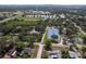 An aerial shot highlights the community's tennis courts, pond, and proximity to sports fields at 1195 S 1St Ave, Bartow, FL 33830