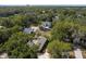 An aerial view shows the home nestled within a canopy of mature trees with ample parking space at 1195 S 1St Ave, Bartow, FL 33830