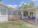 A backyard featuring a small wooden deck with covered patio and ample backyard grass at 1195 S 1St Ave, Bartow, FL 33830